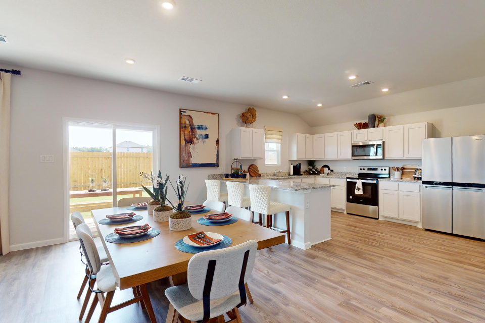 A kitchen with a dining table.