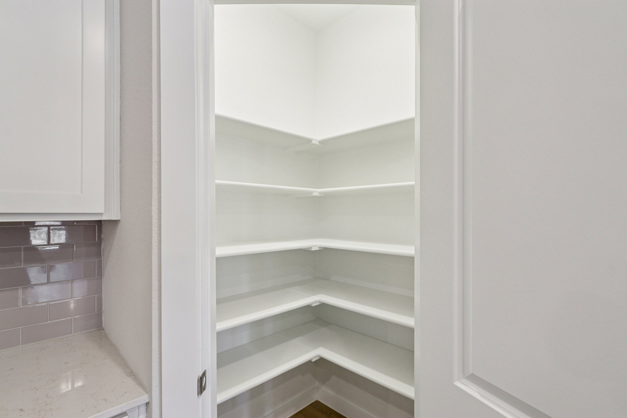 A white shelf in a room.