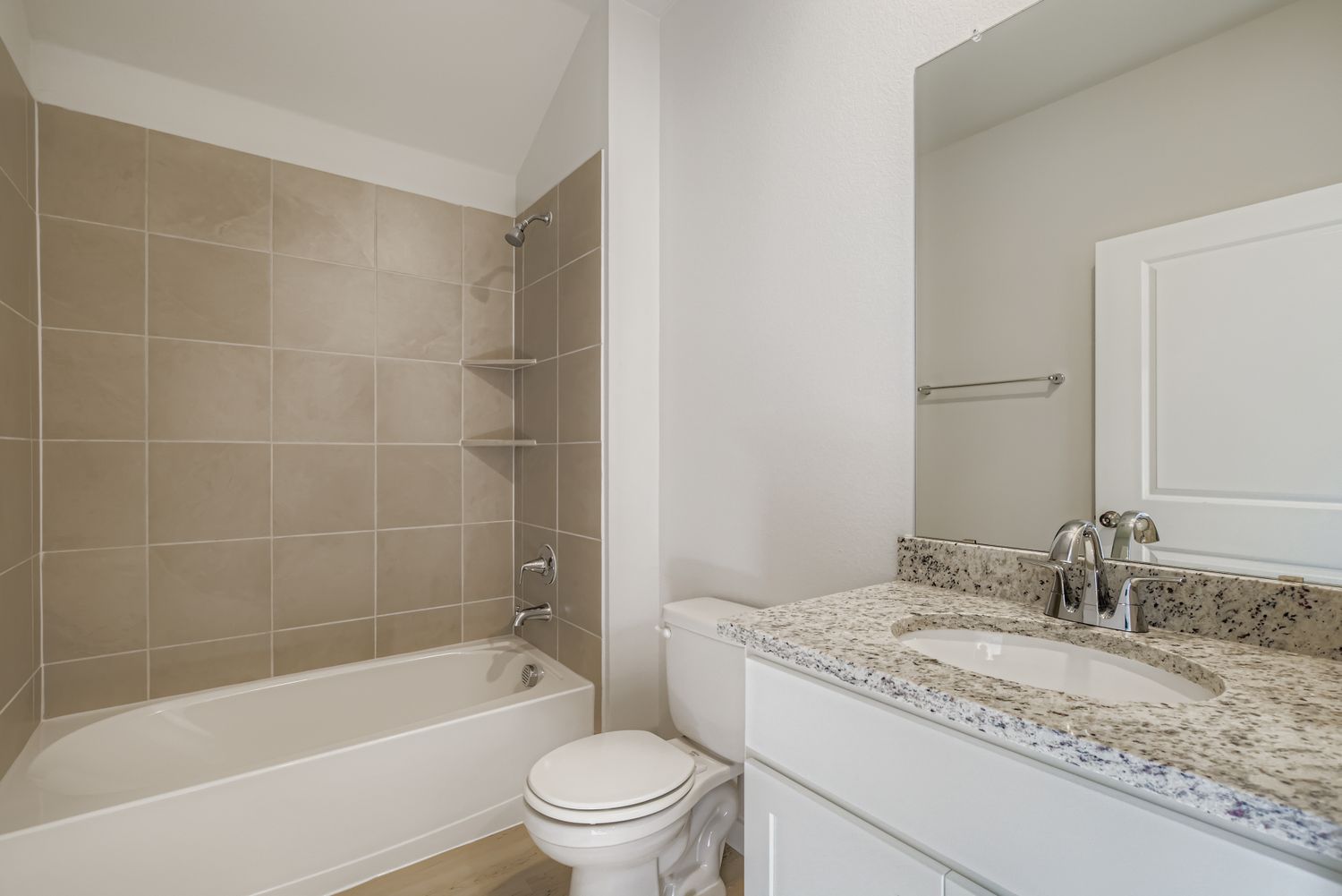 A bathroom with a tub sink and toilet.