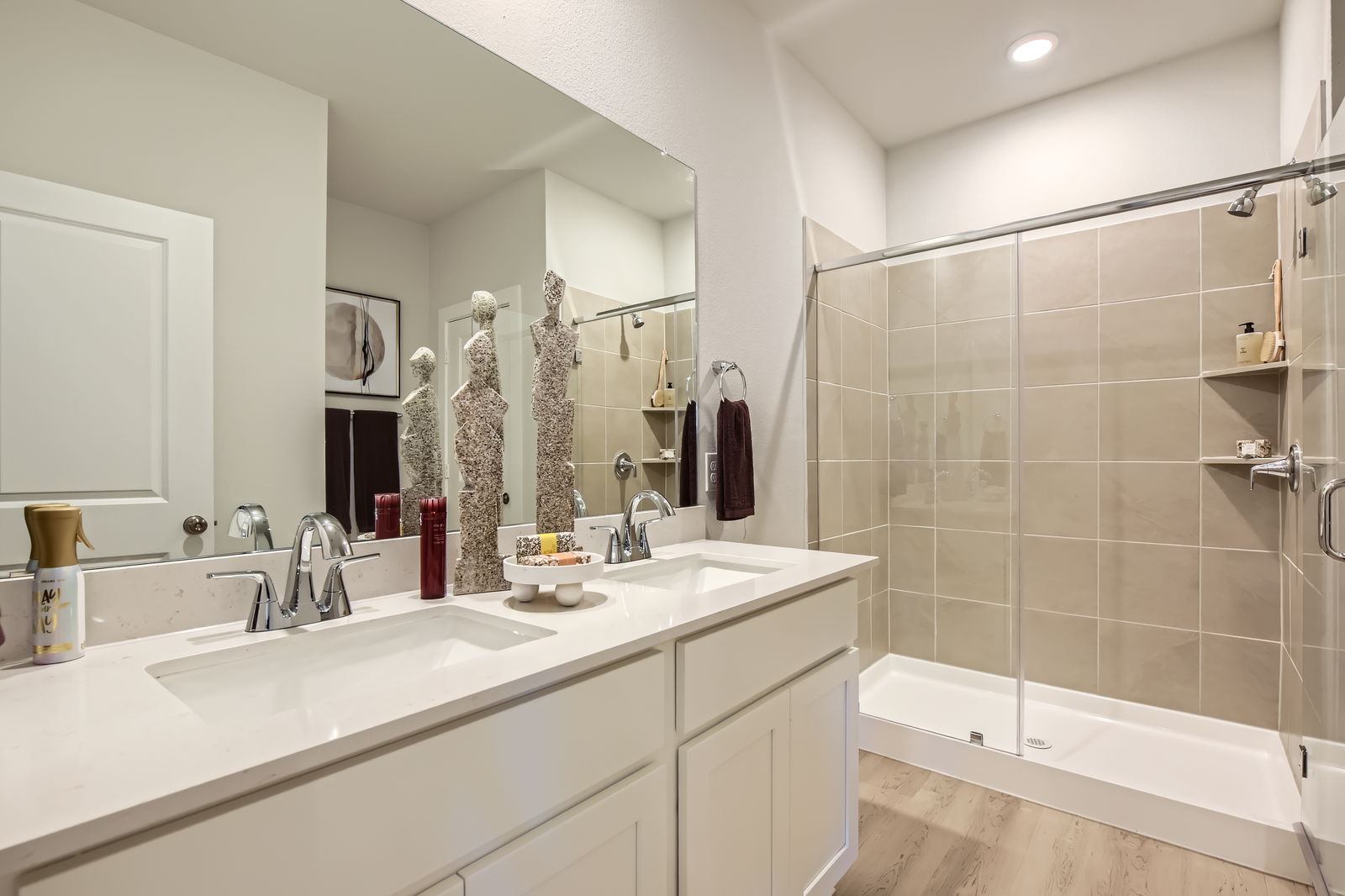 A bathroom with a large mirror.