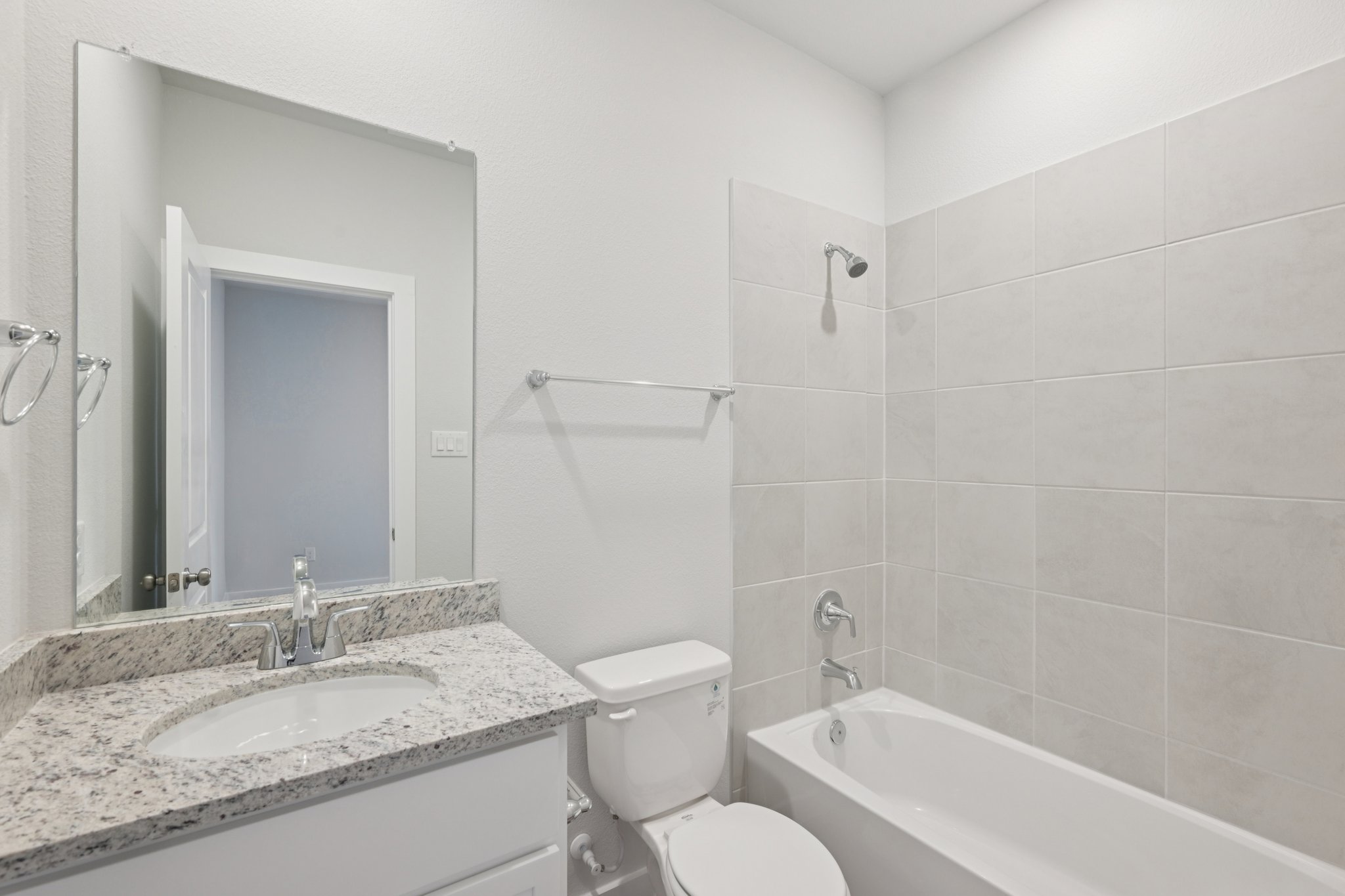 A bathroom with a sink toilet and bathtub.