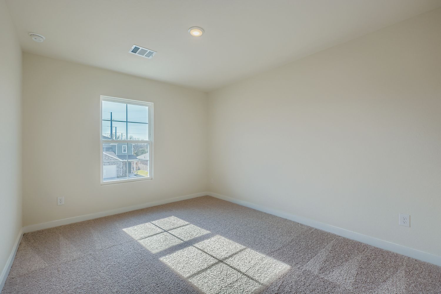 A room with a window and a tile floor.