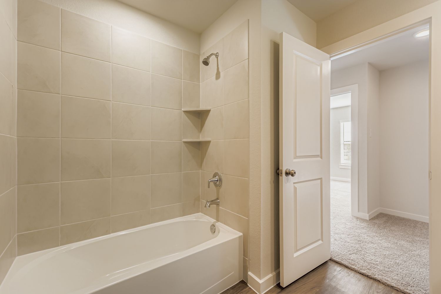 A bathroom with a bathtub and a shower unit.
