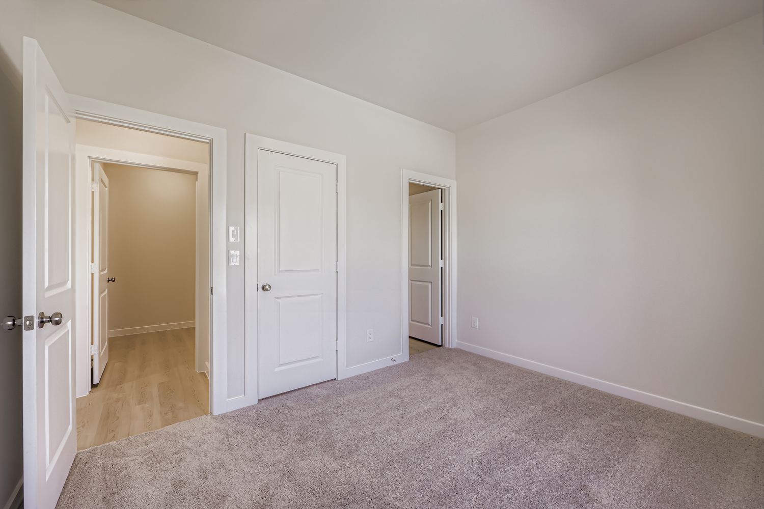 A hallway with white doors.