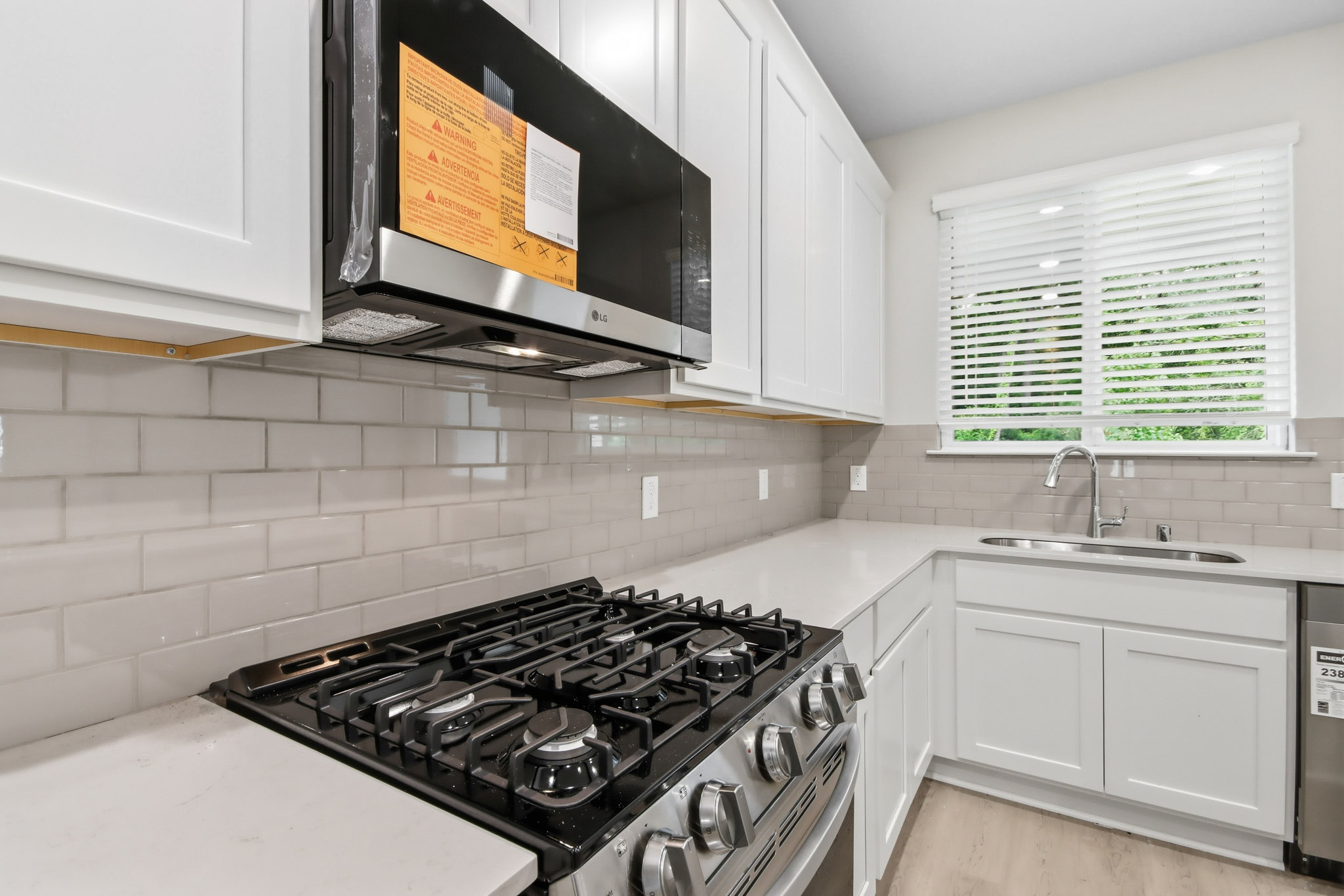 A kitchen with white cabinets.