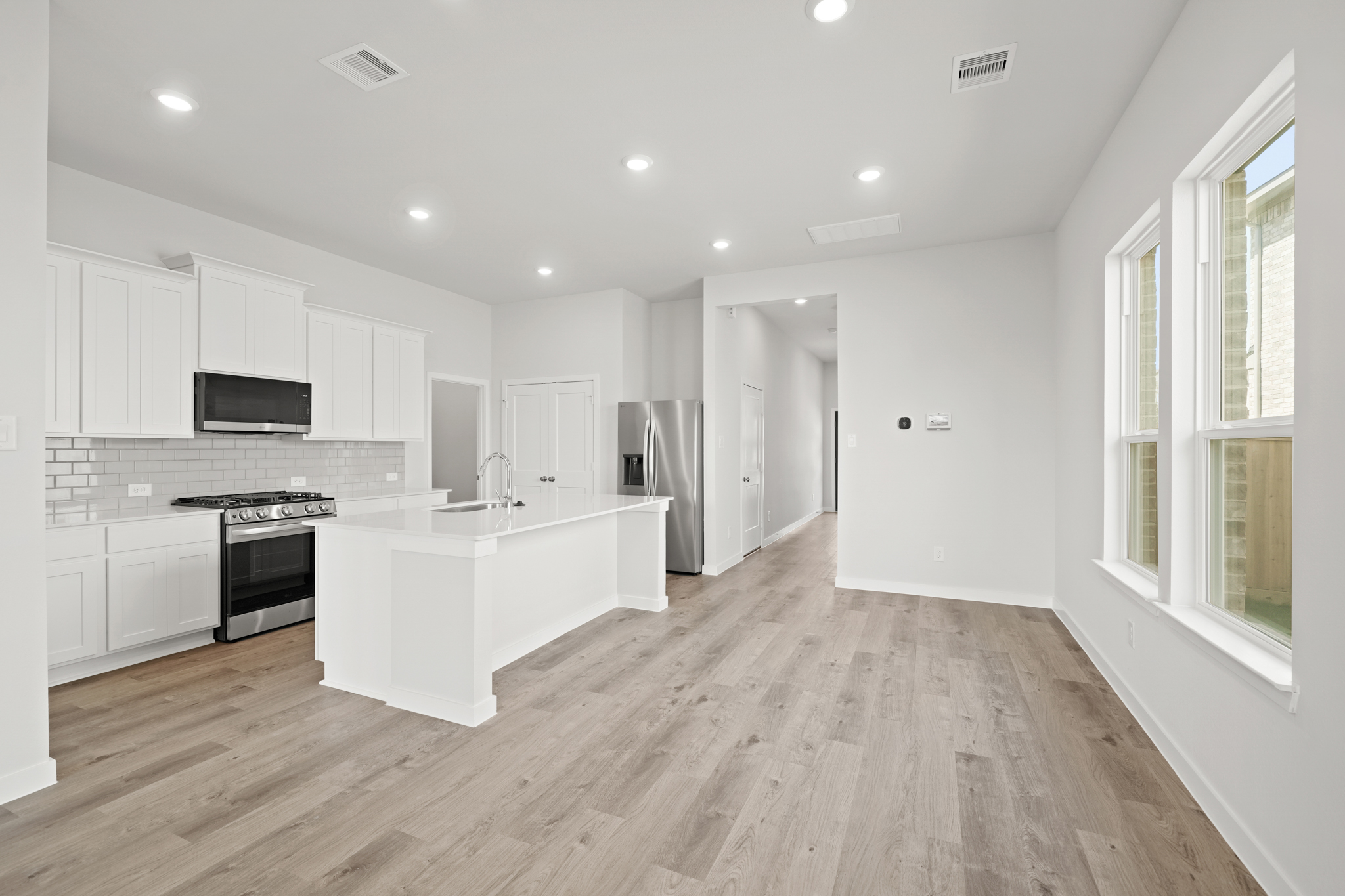 A kitchen with white cabinets.