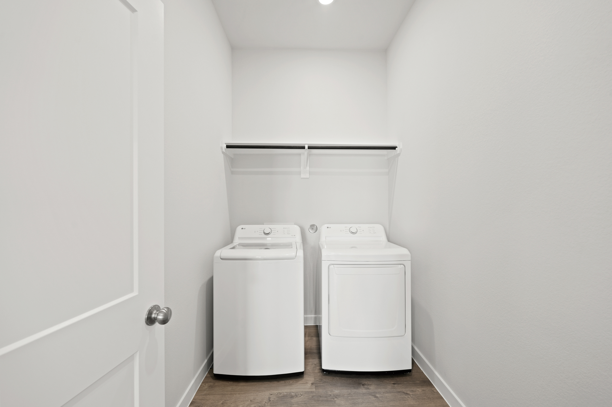 A white room with a washer and dryer.