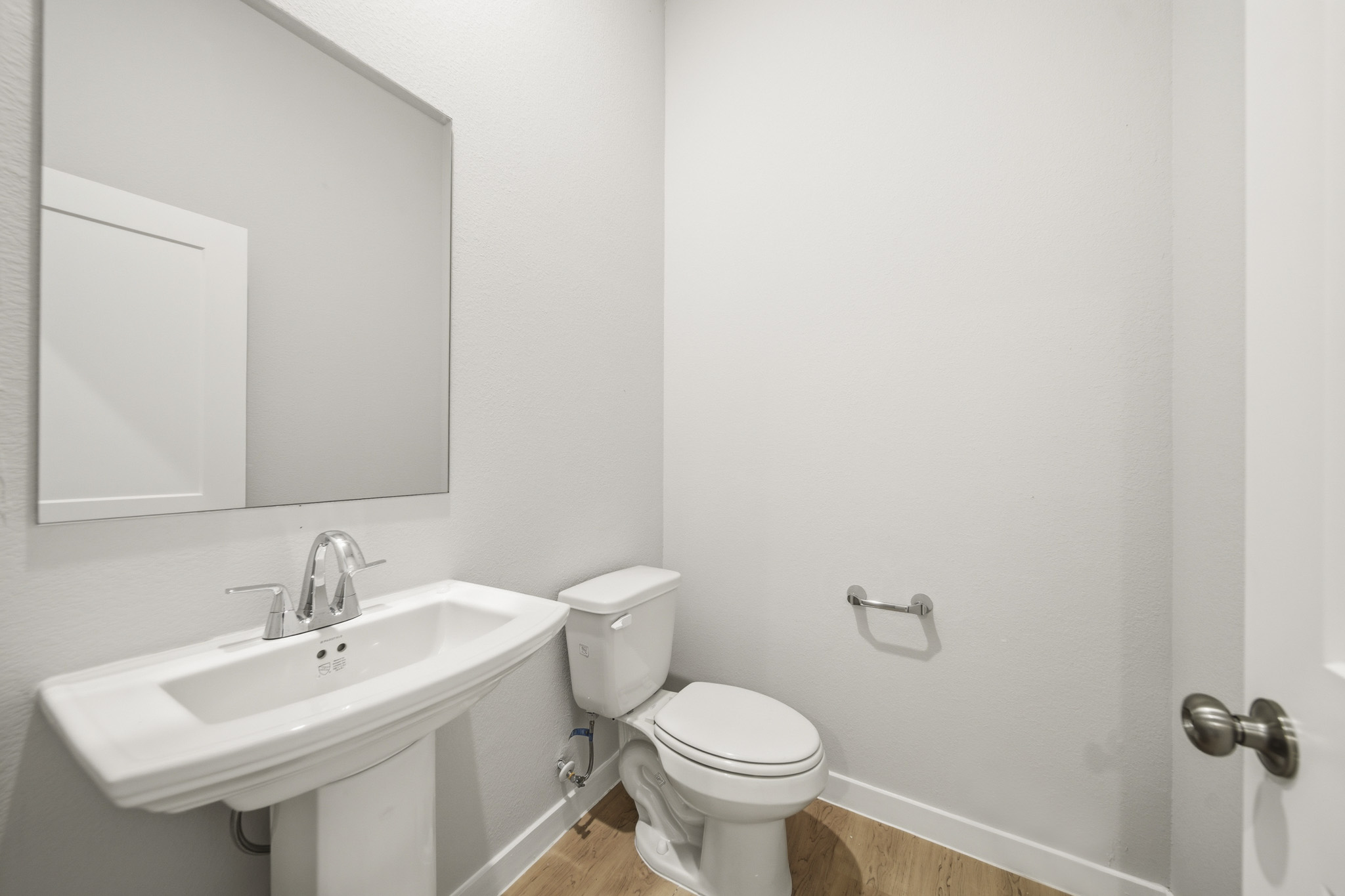 A bathroom with a toilet and sink.