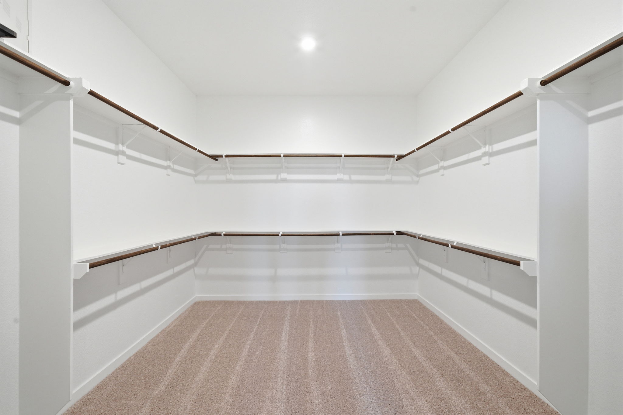 A white room with a wood floor.