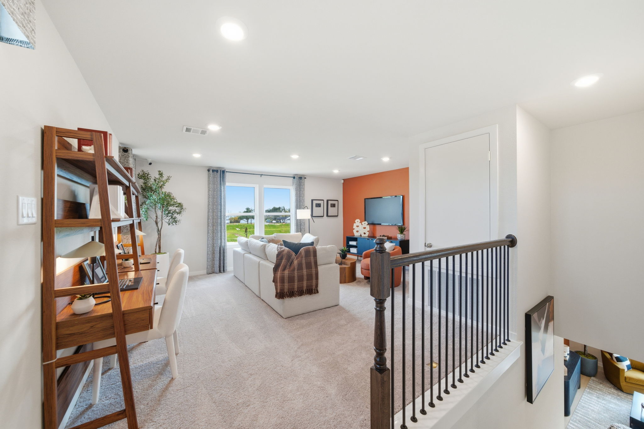 A living room with a bed and a chair.