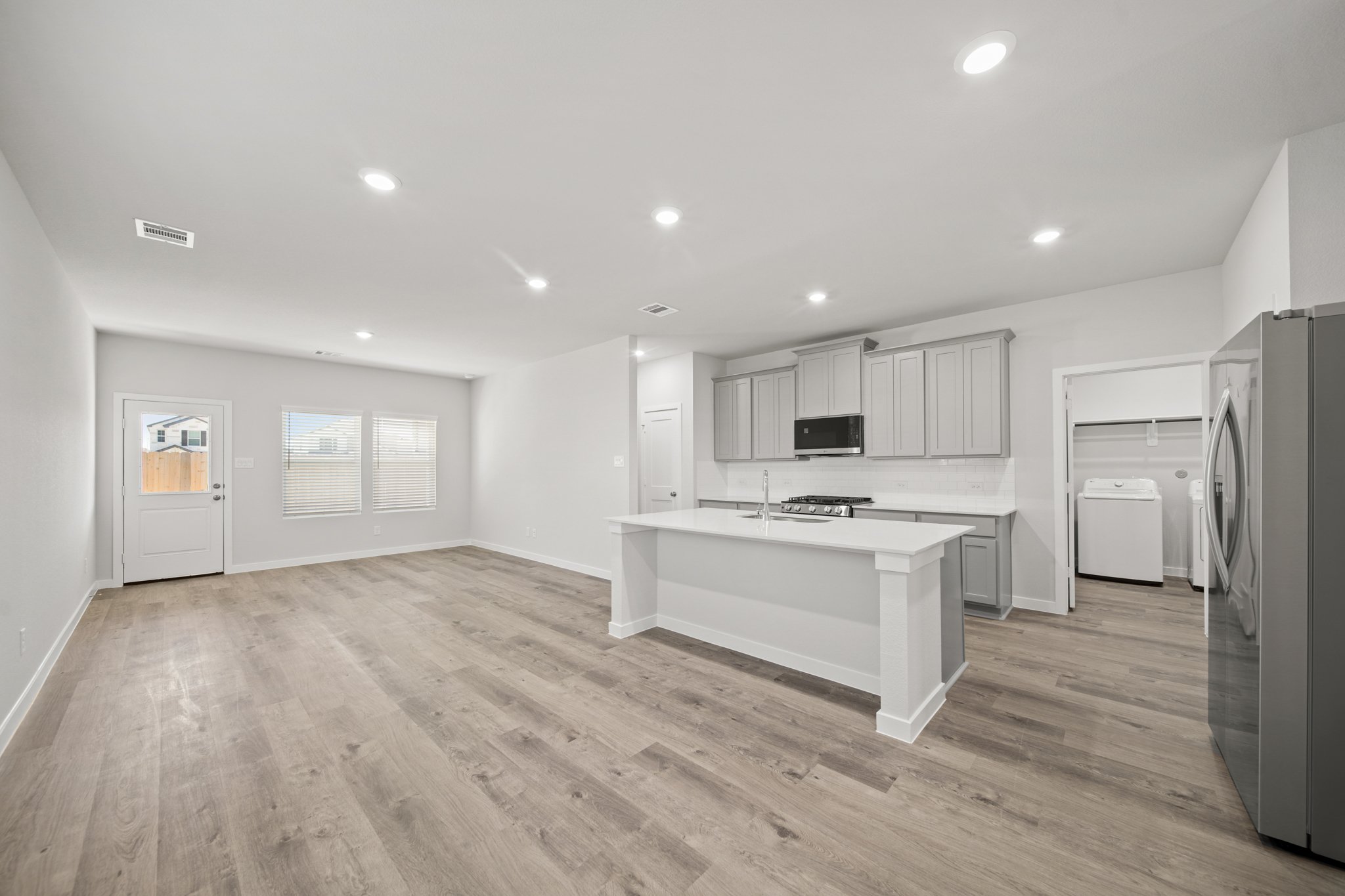 A kitchen with white cabinets.