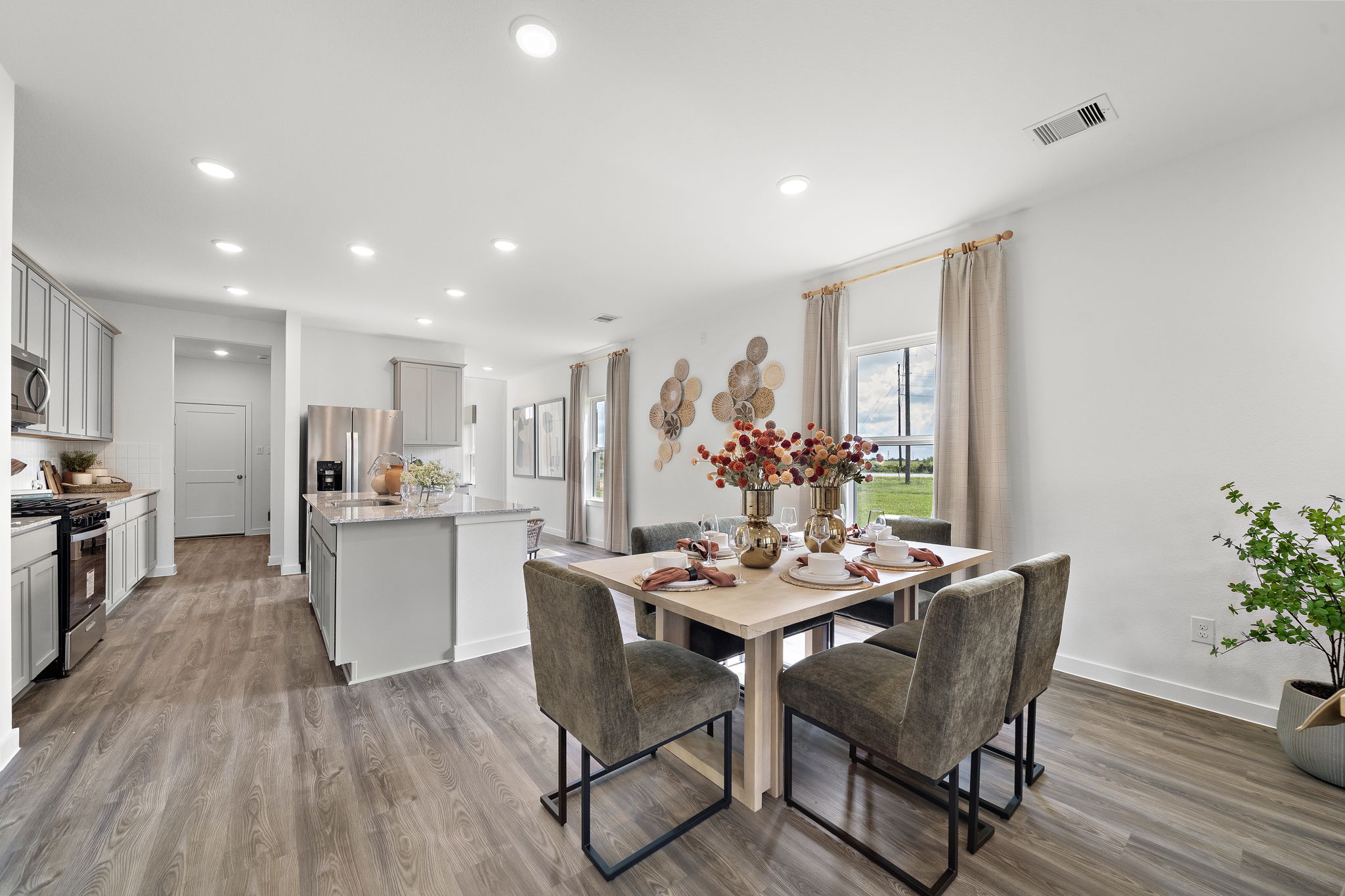 A dining room with a table and chairs.