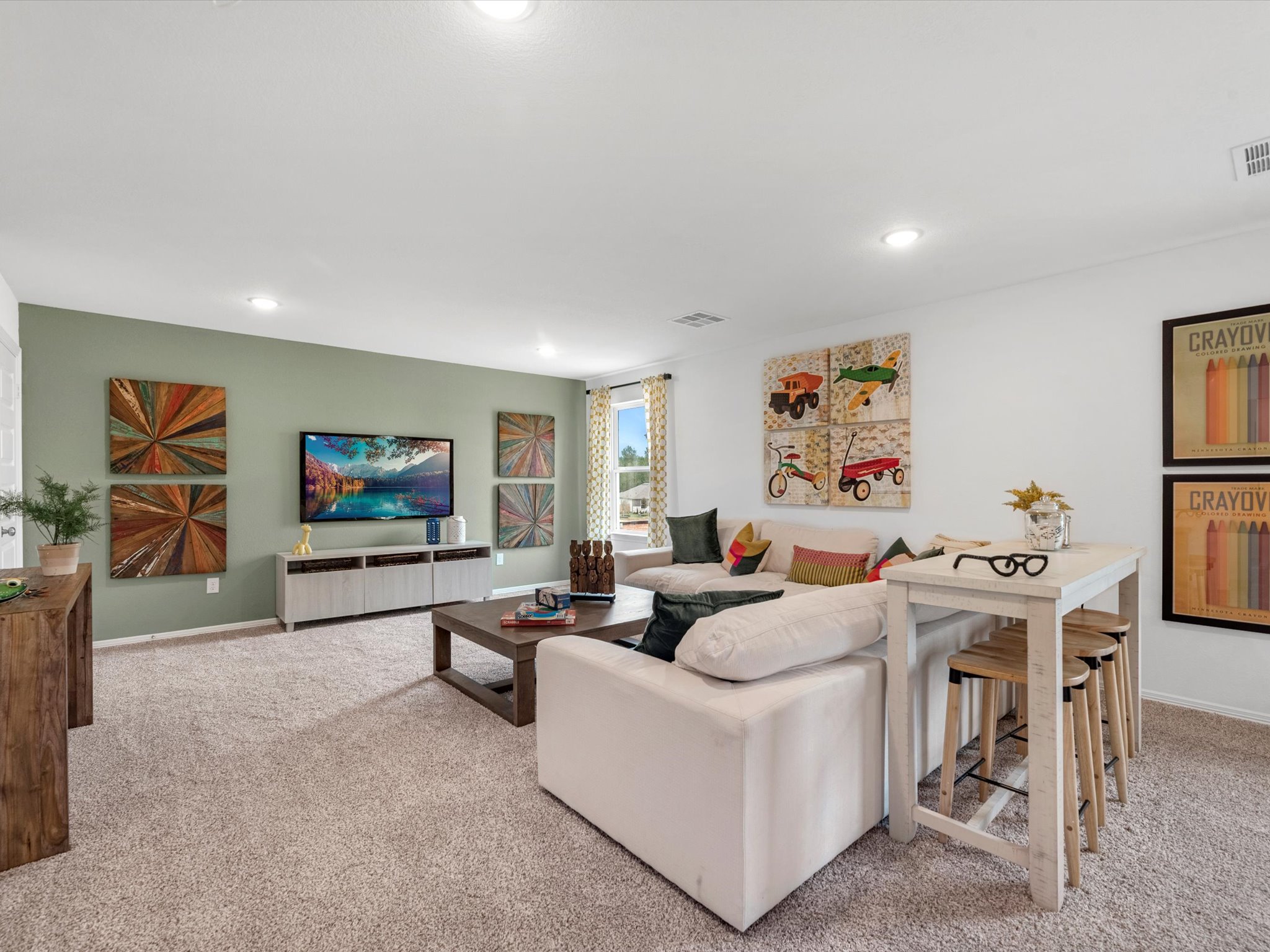 A living room with art on the wall.