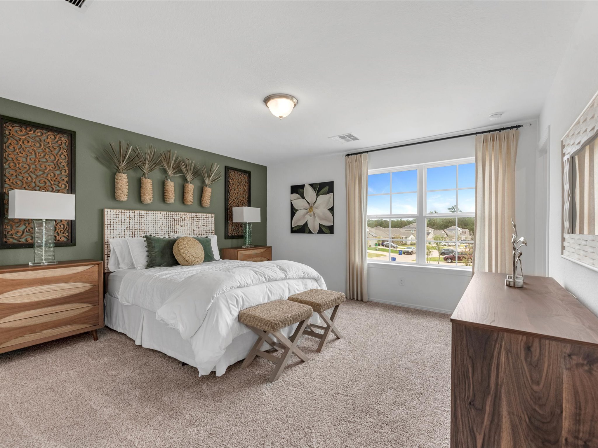 A bedroom with a bed and a bench.