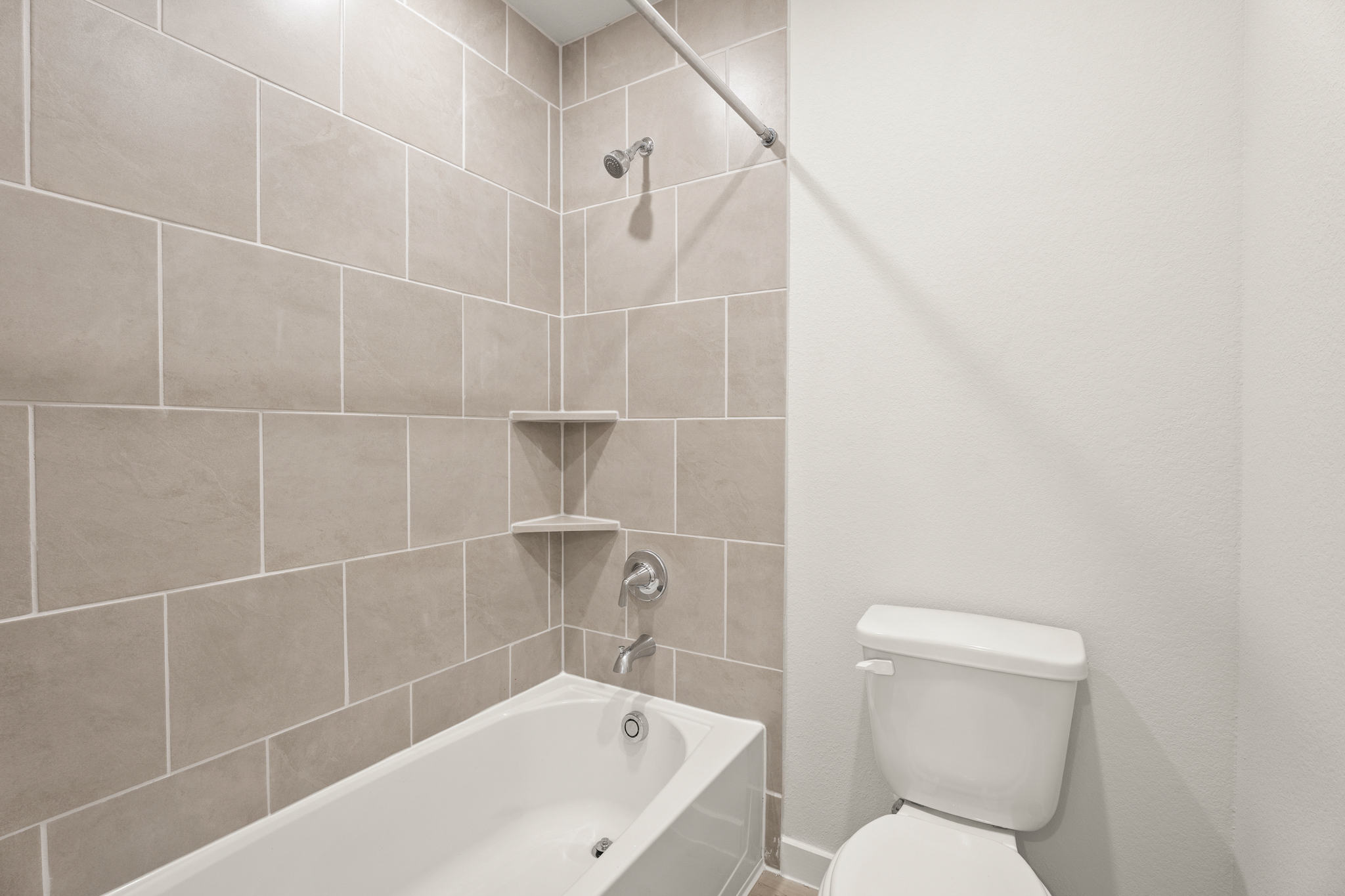 A bathroom with a bathtub toilet and sink.