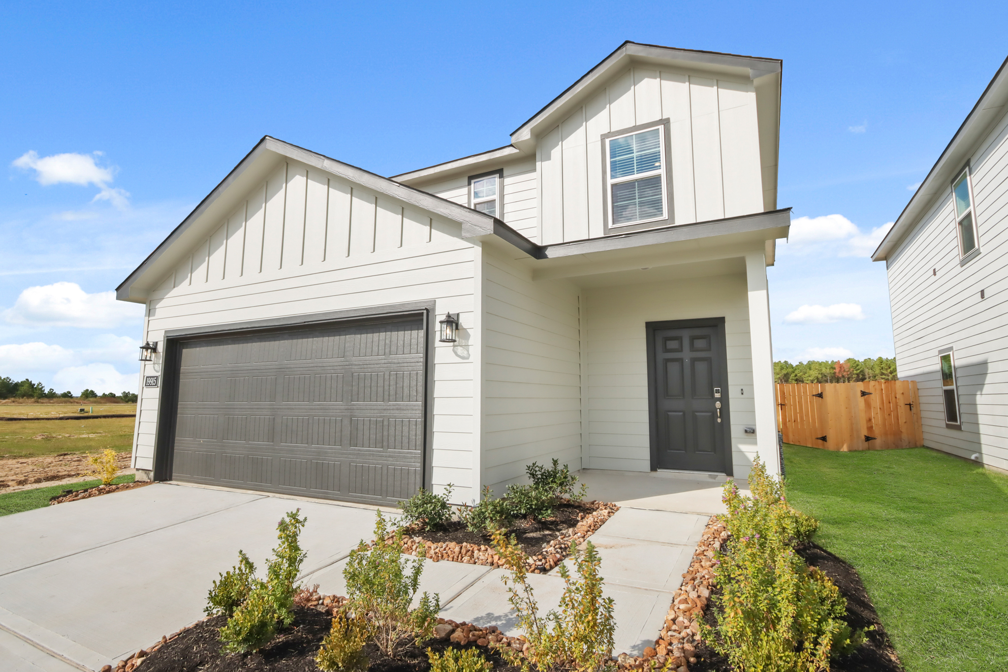 A white house with a garage.