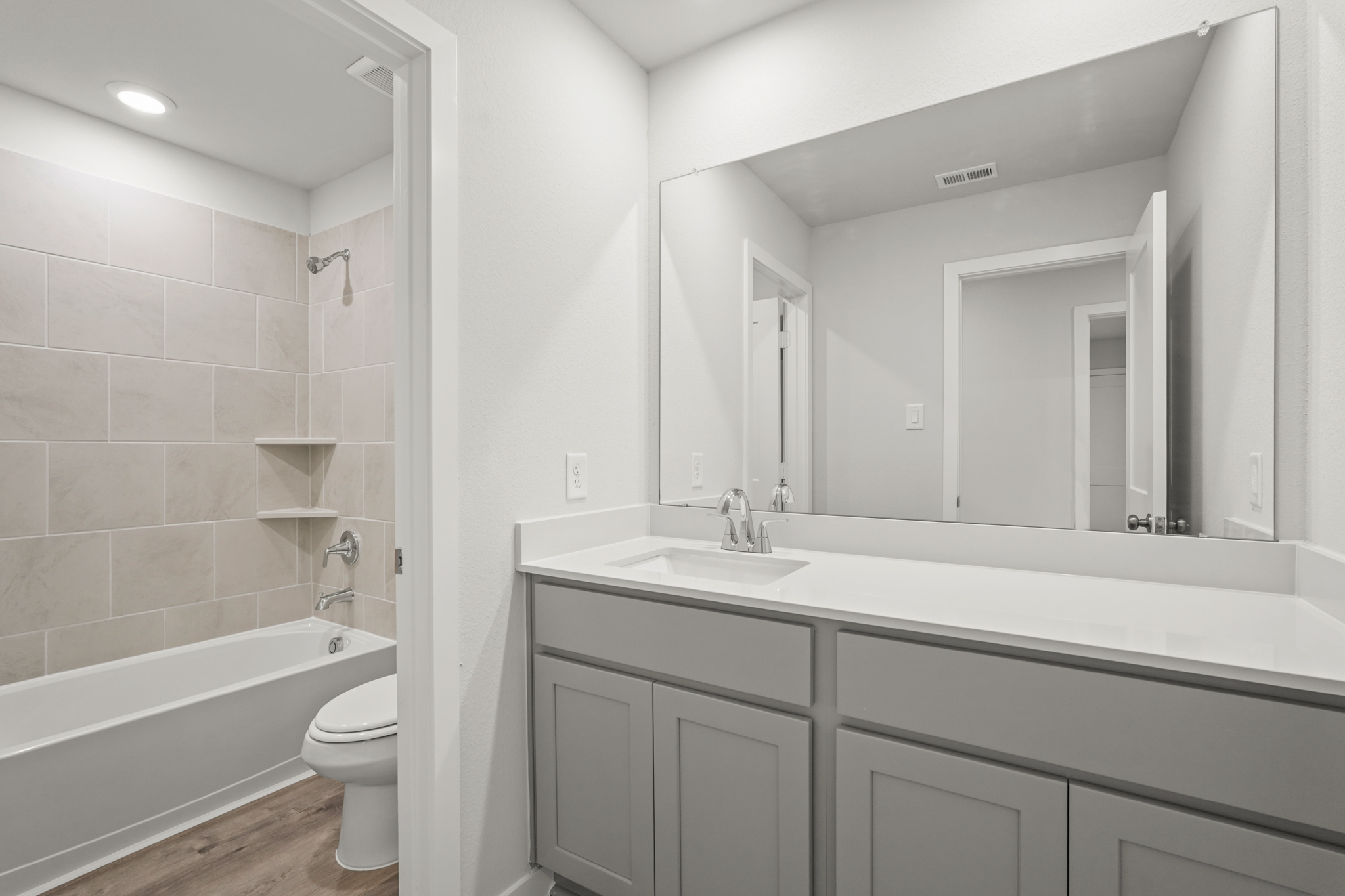 A bathroom with a tub sink and toilet.