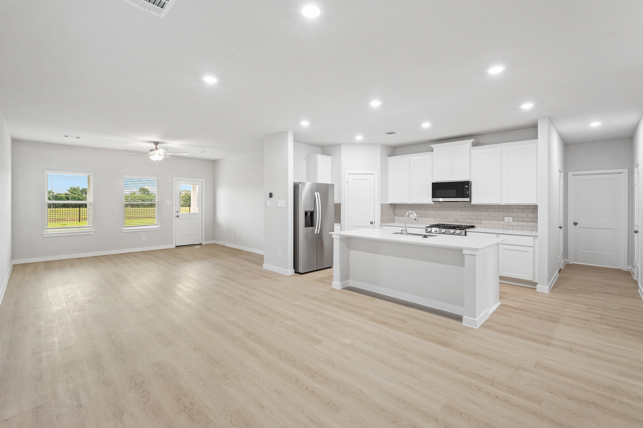 A large kitchen with white cabinets.
