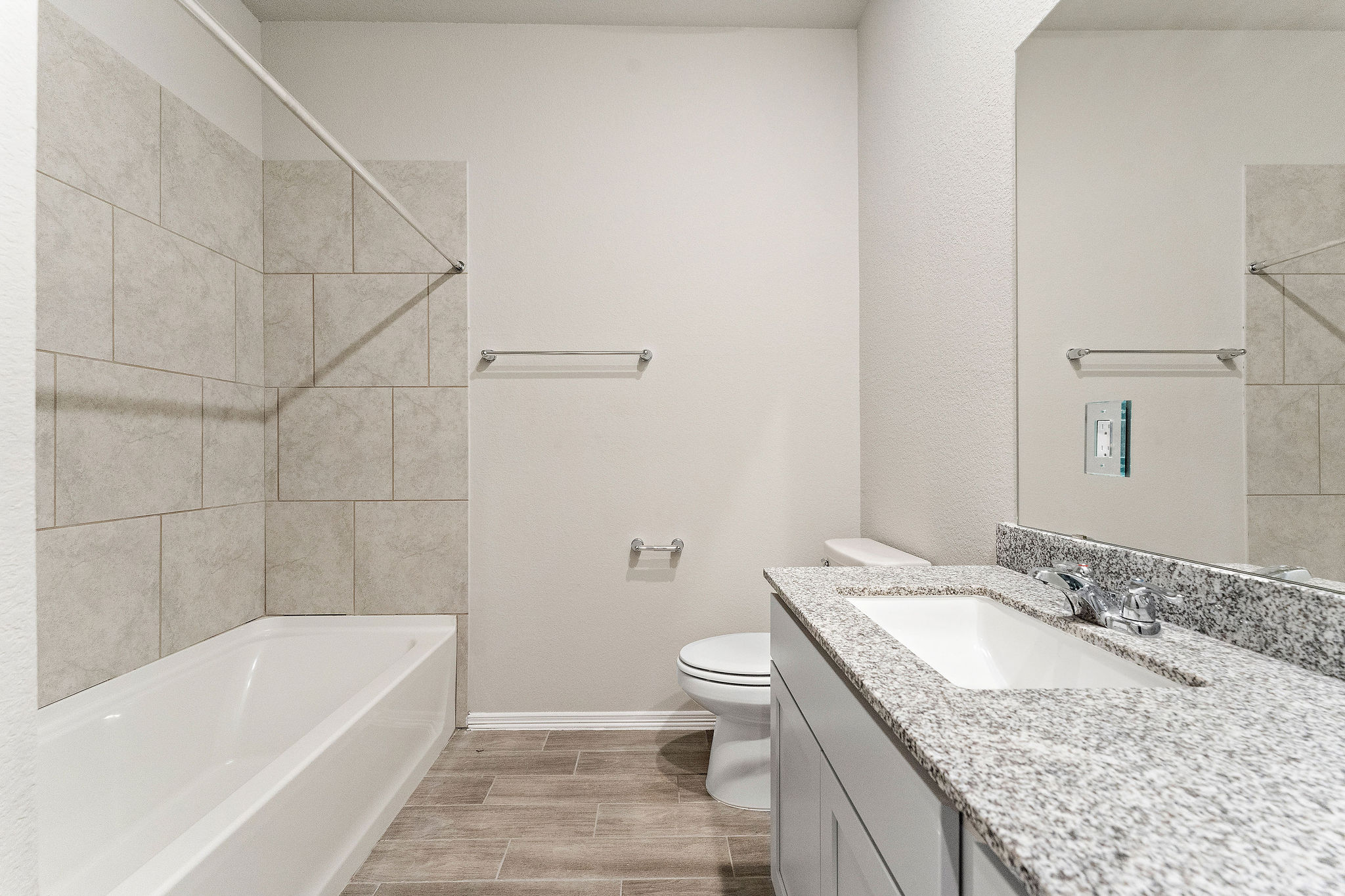 A bathroom with a marble countertop.