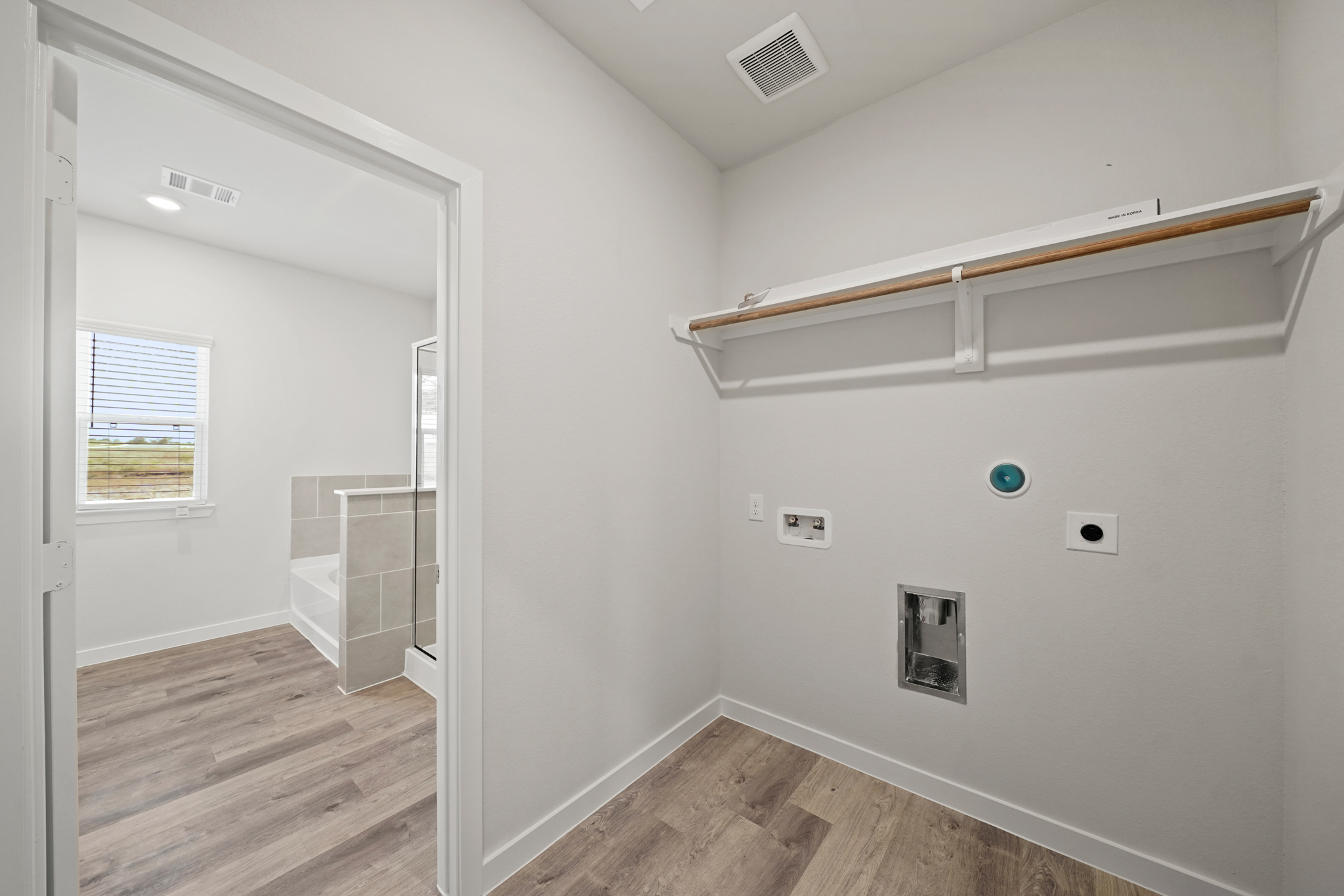 A bathroom with a white wall.