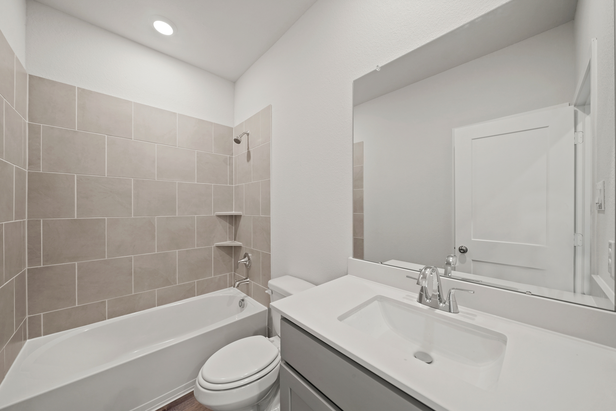A bathroom with a tub sink and toilet.