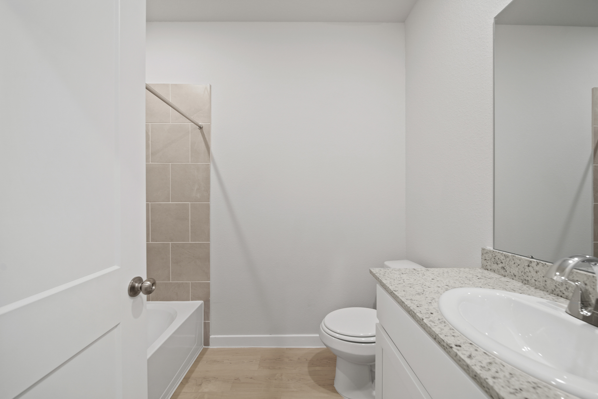 A bathroom with a toilet sink and a bathtub.