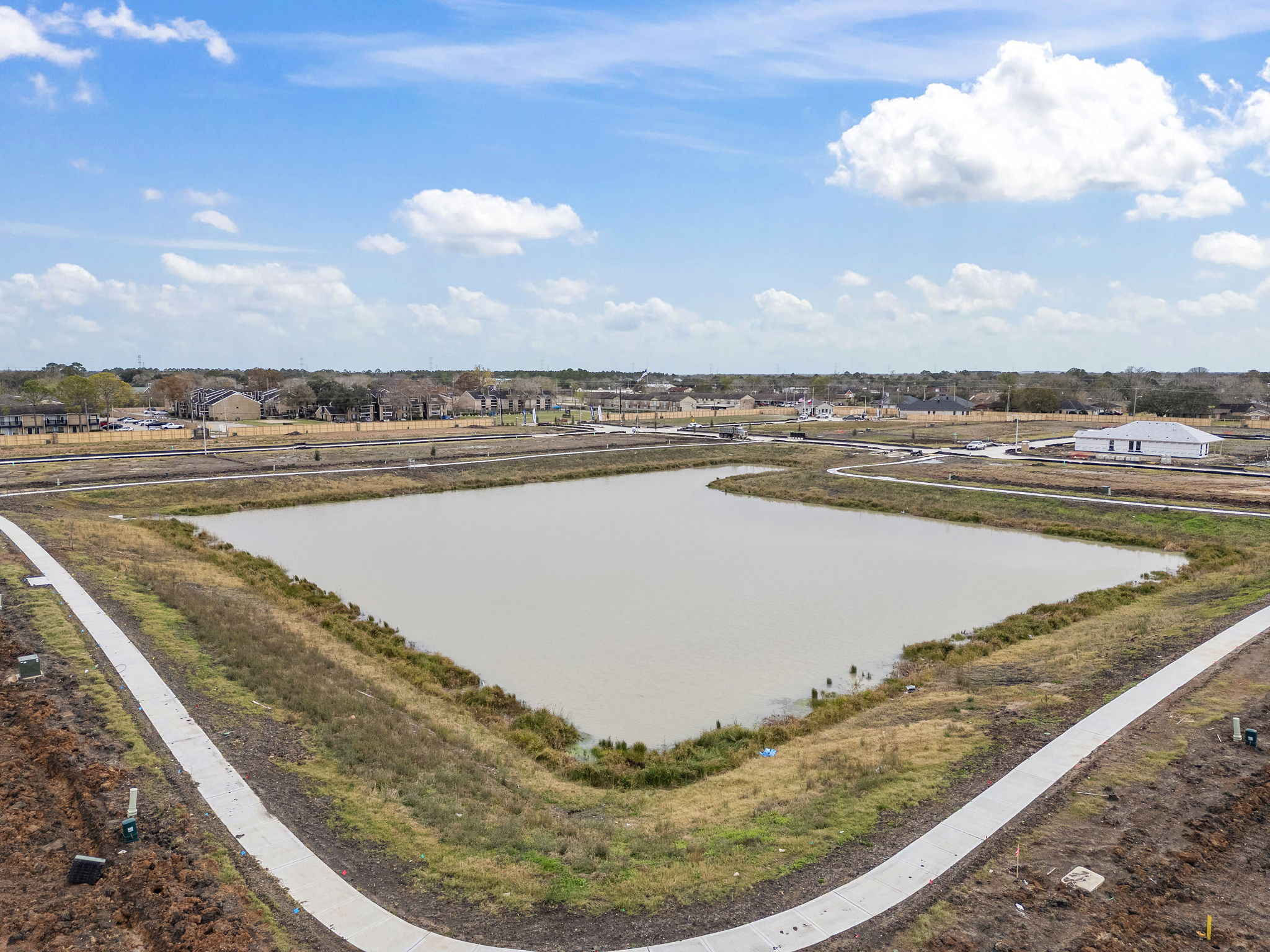 A river with a road and buildings in the background.