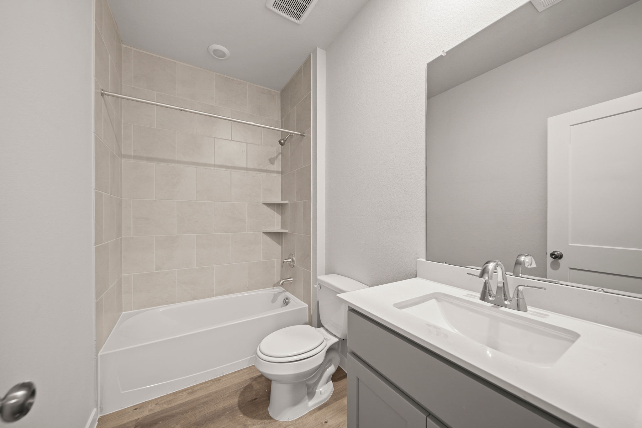 A bathroom with a tub sink and toilet.