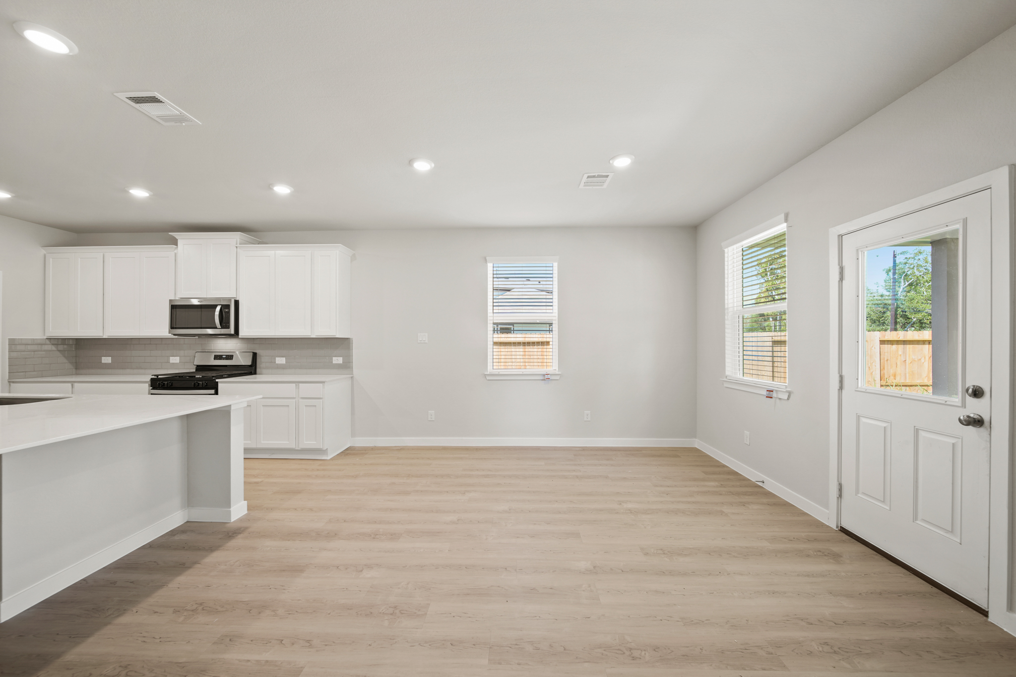 A kitchen with white cabinets.