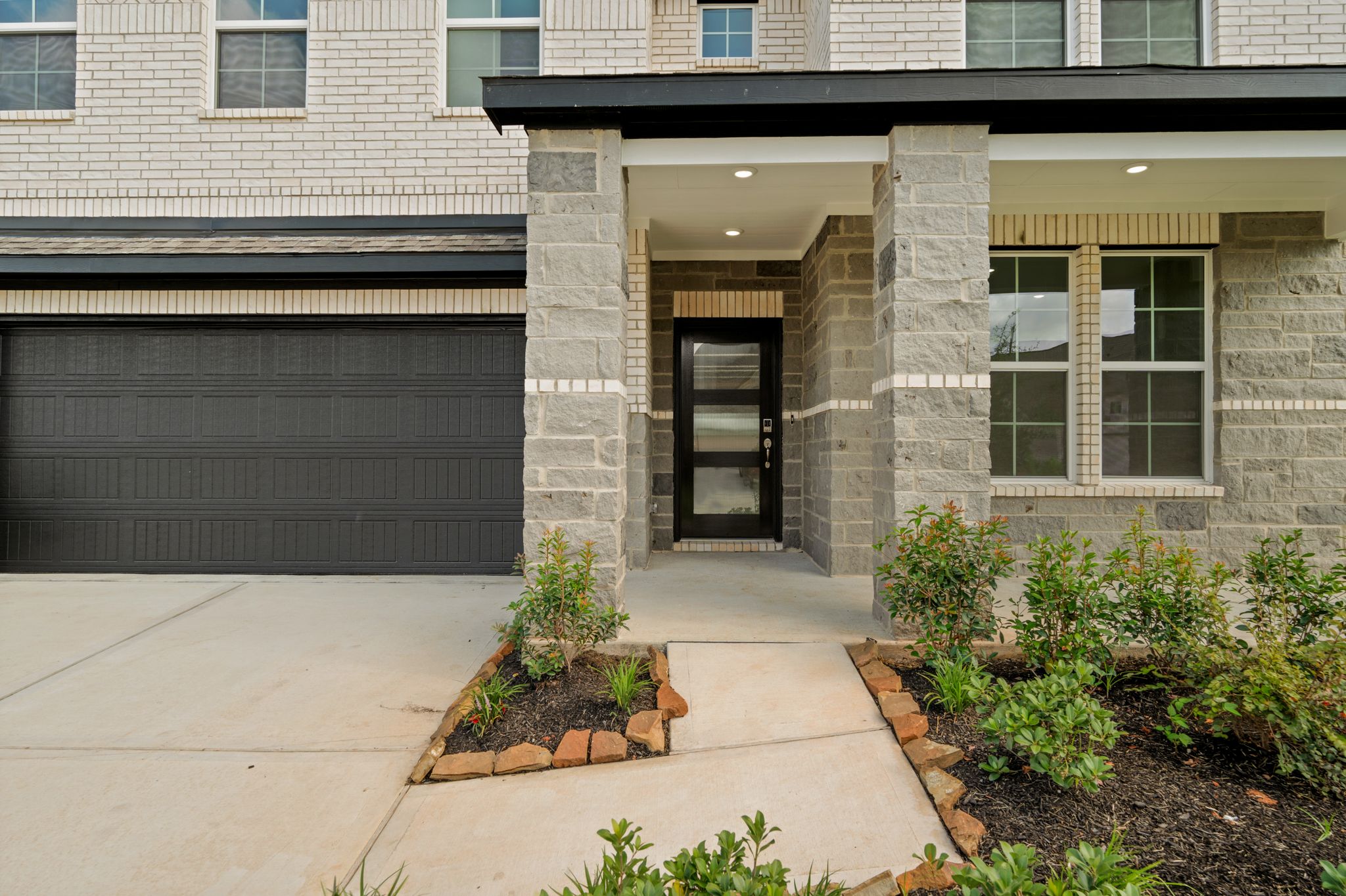 A building with a garage and a door.