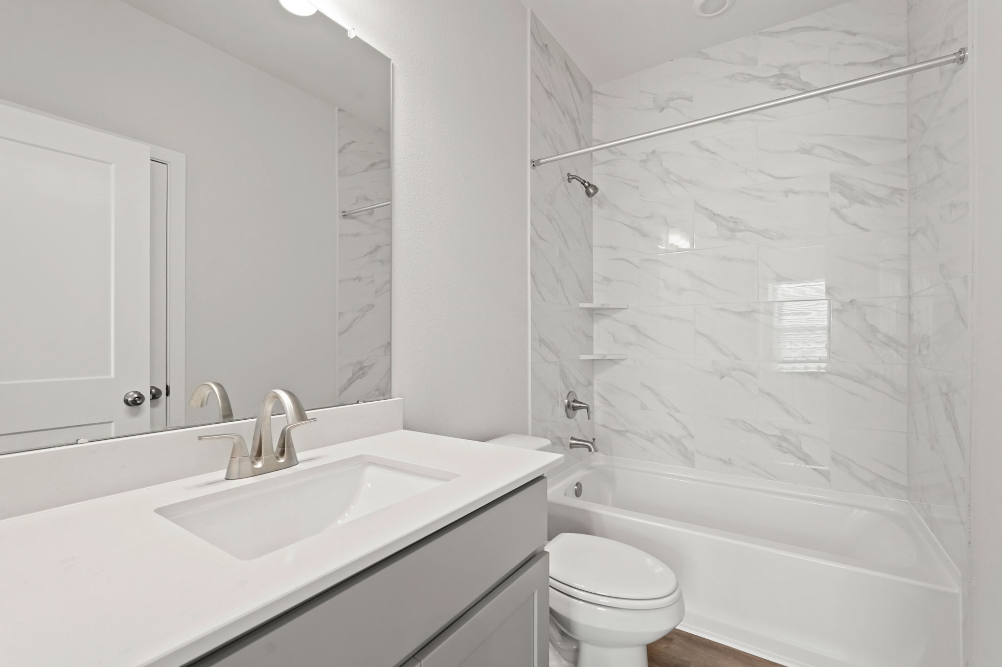 A bathroom with a tub sink and toilet.