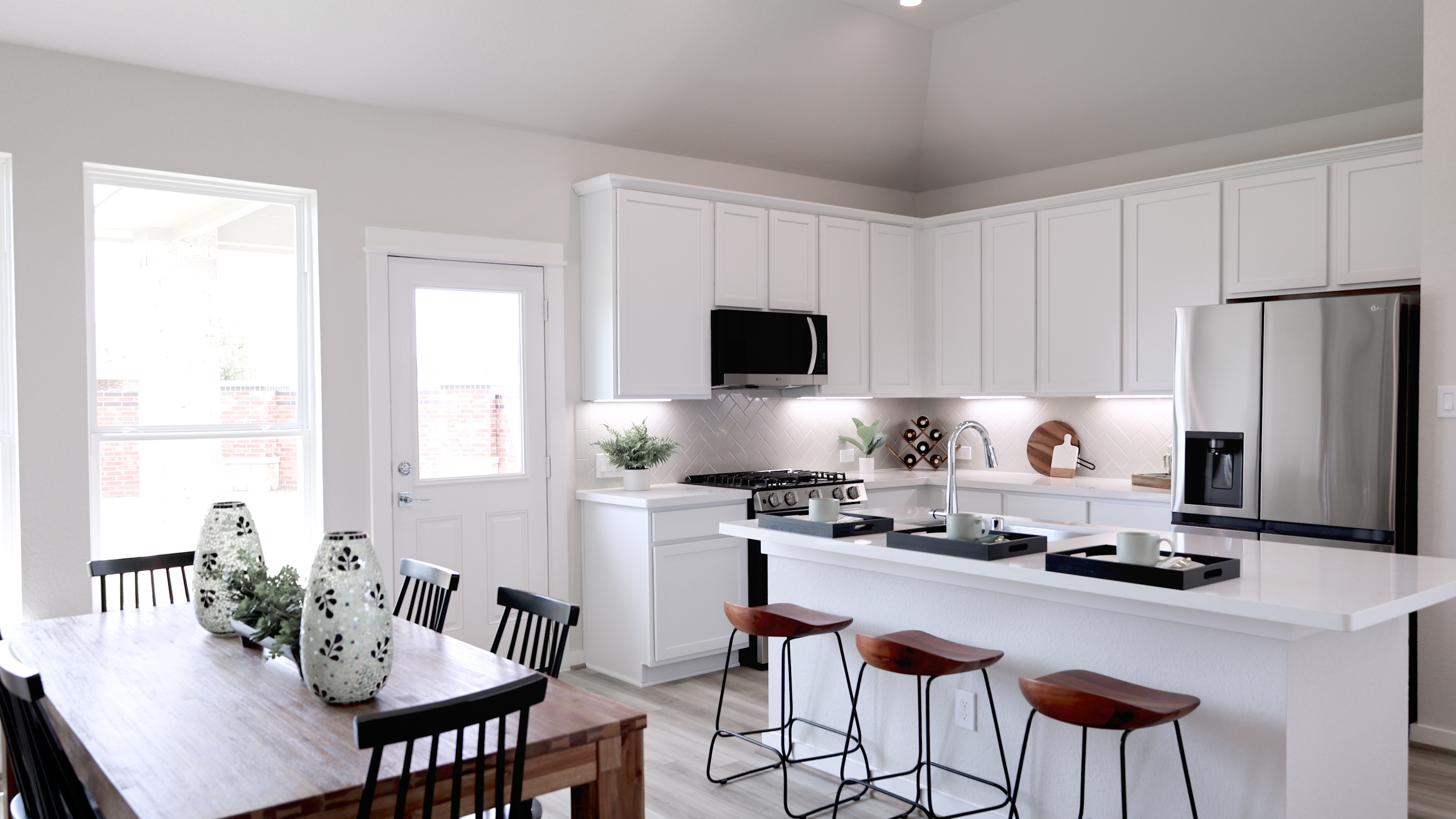 A kitchen with white cabinets.