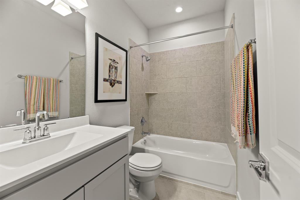 A bathroom with a tub sink and toilet.