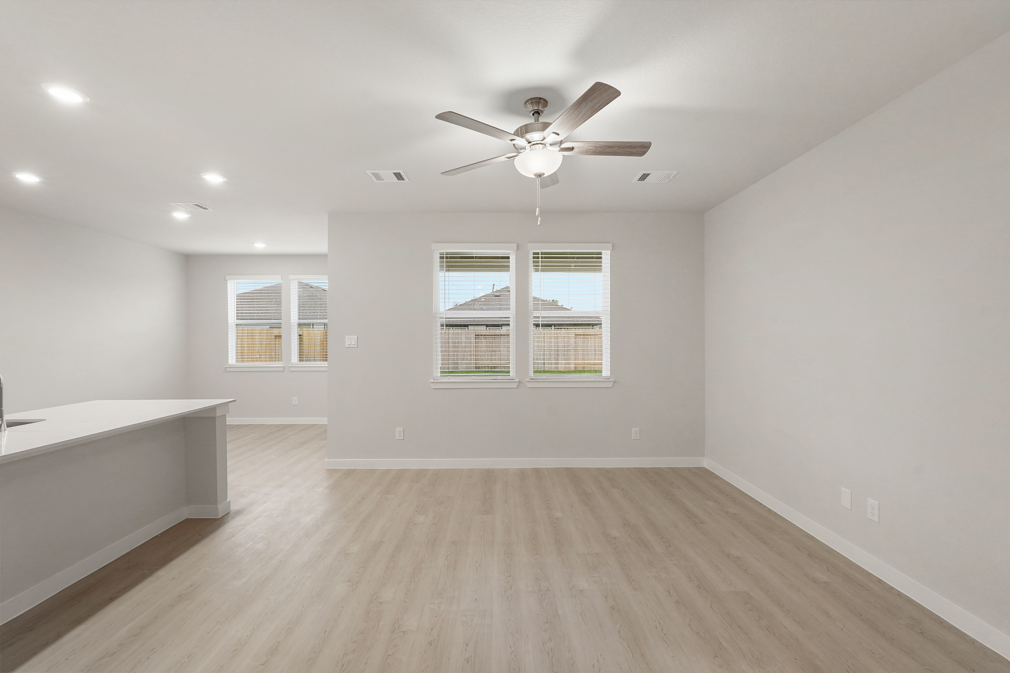A room with a bed and a ceiling fan.