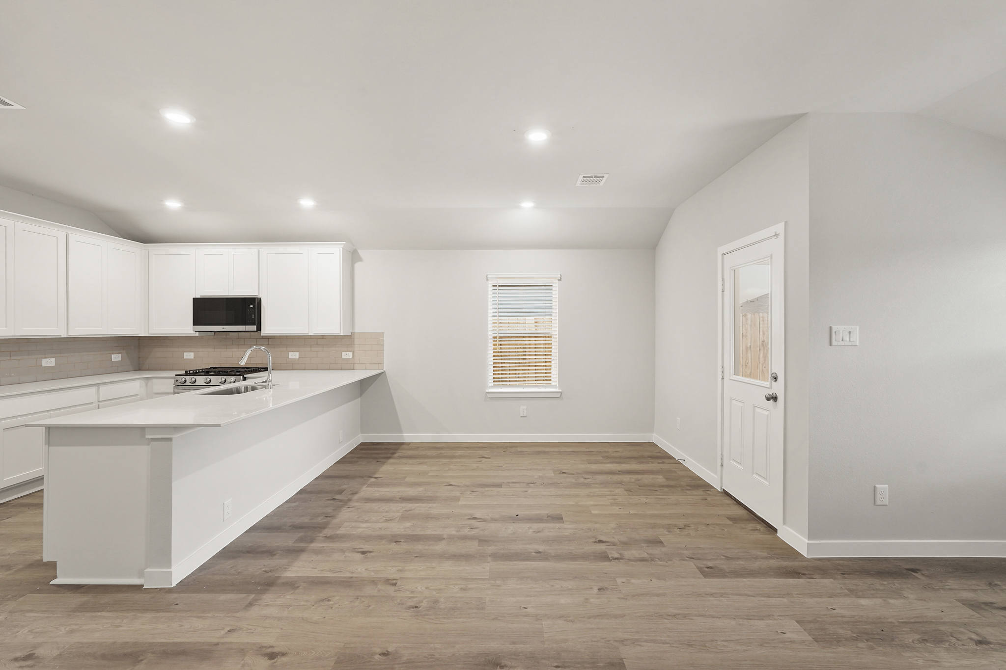 A kitchen with white cabinets.