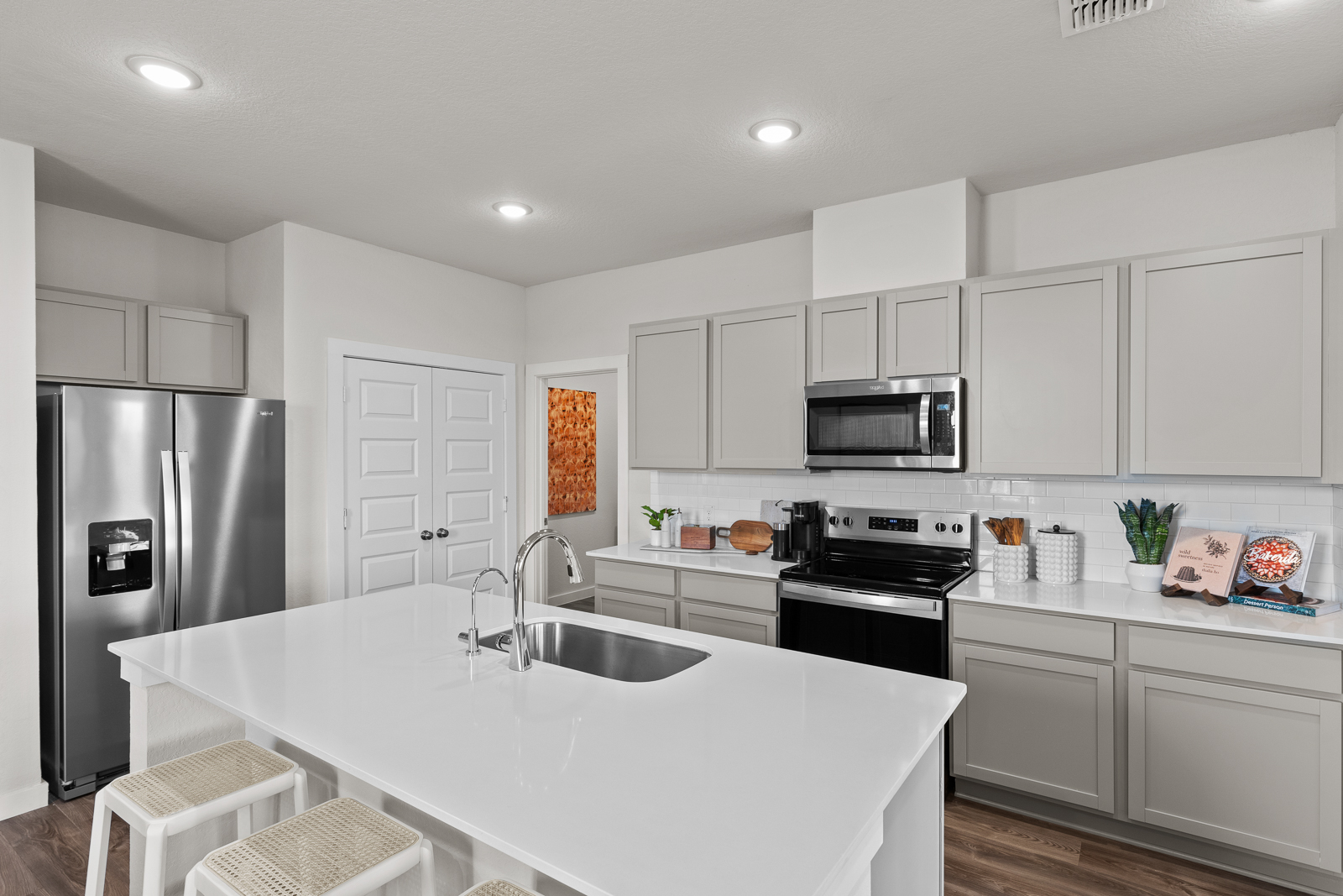 A kitchen with white cabinets.