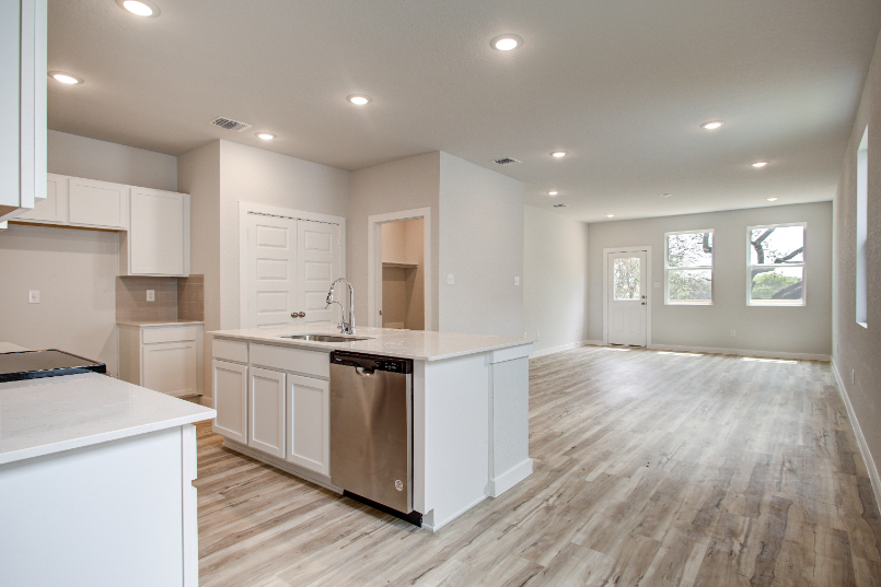 A kitchen with white cabinets.