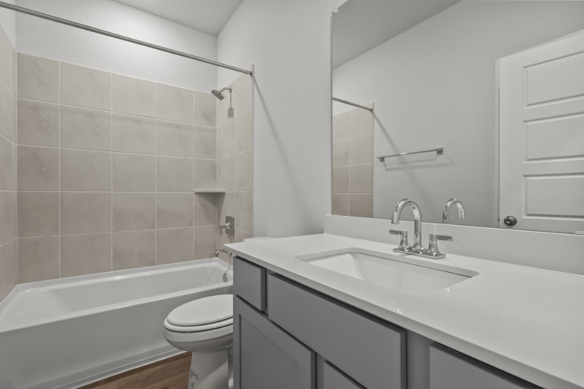 A bathroom with a sink toilet and bathtub.