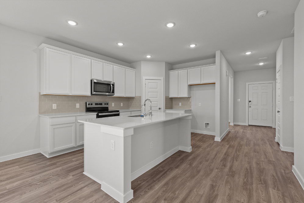 A kitchen with white cabinets.