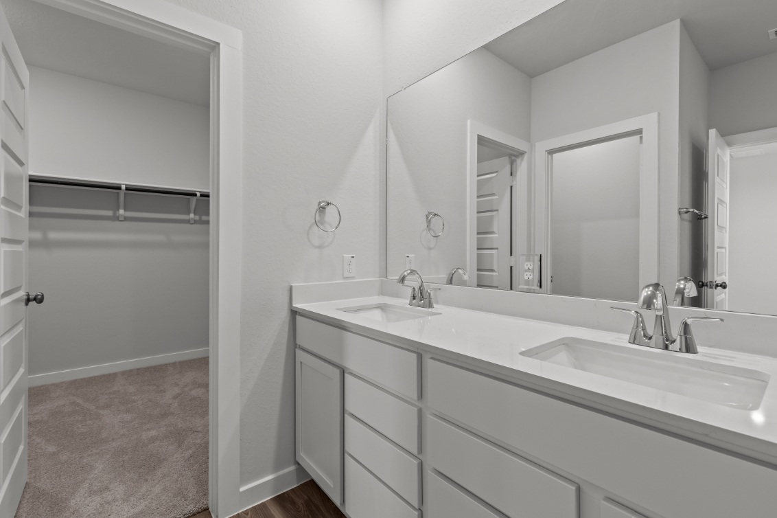 A bathroom with a large mirror.