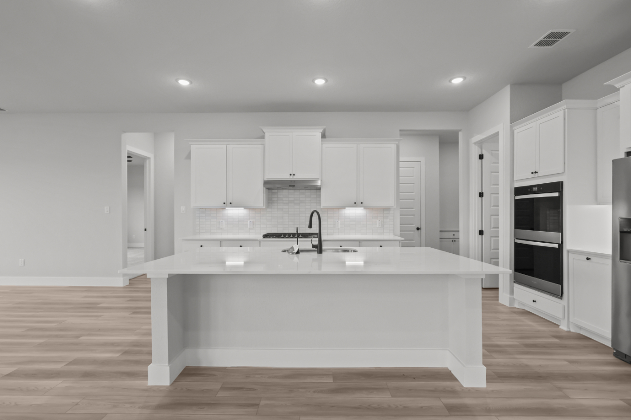 A kitchen with white cabinets.