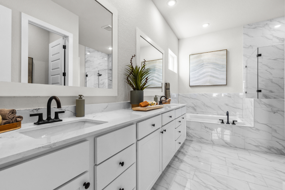 A bathroom with white cabinets.