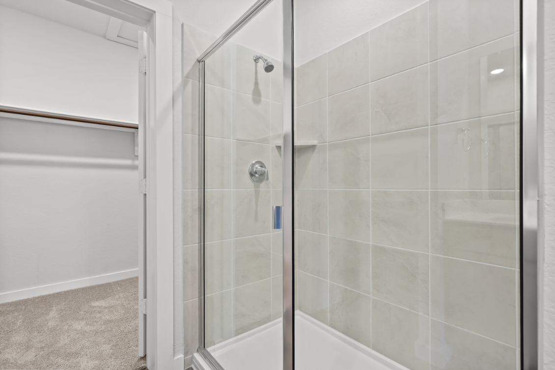 A shower with a glass door.