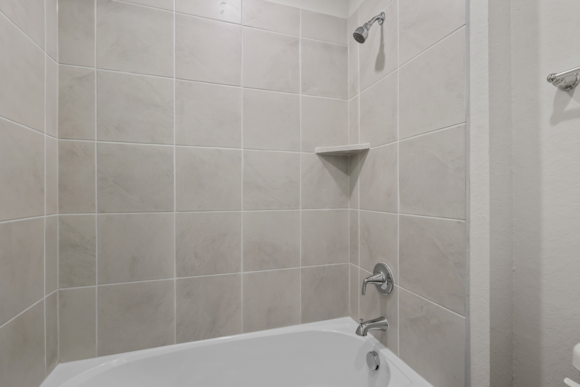 A bathtub and a shower unit.