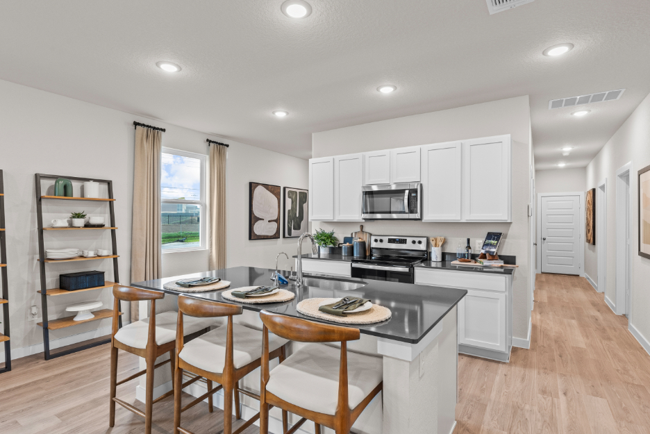 A kitchen with a dining table.