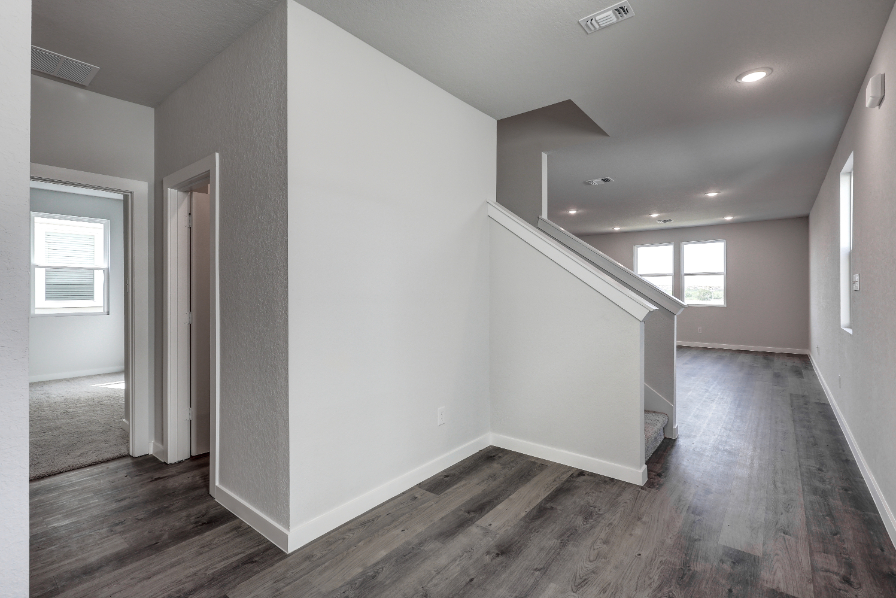 A room with a wood floor and white walls.