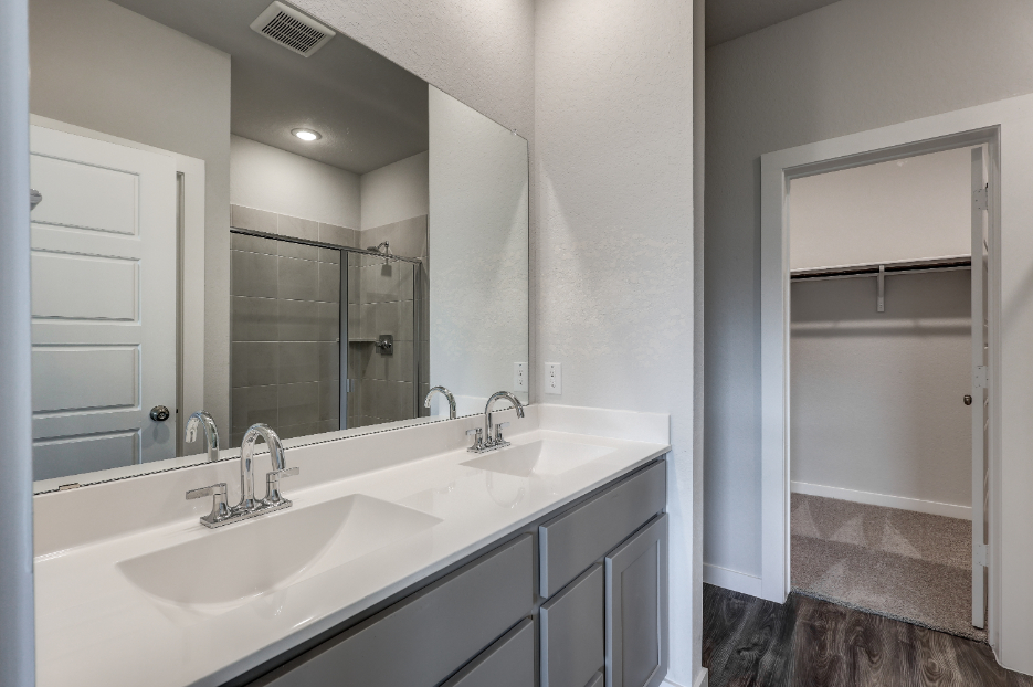 A bathroom with a large mirror.