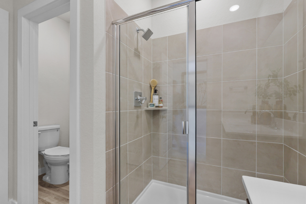 A shower with a glass door.
