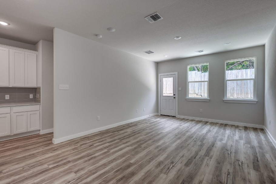 A room with a wood floor and white walls.