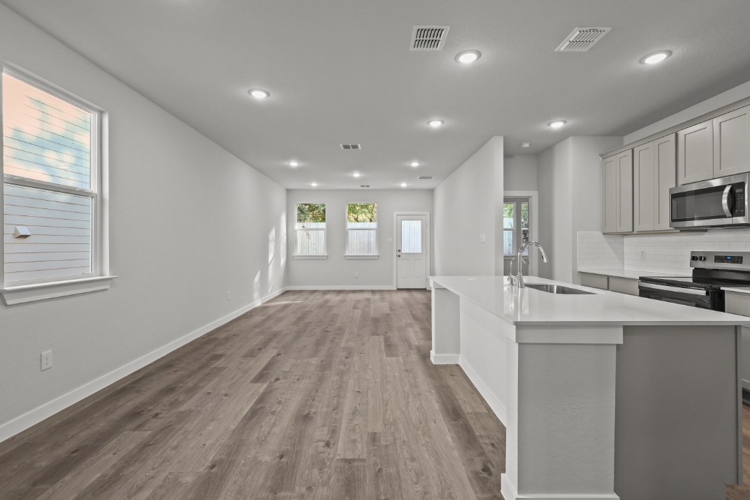 A kitchen with white cabinets.